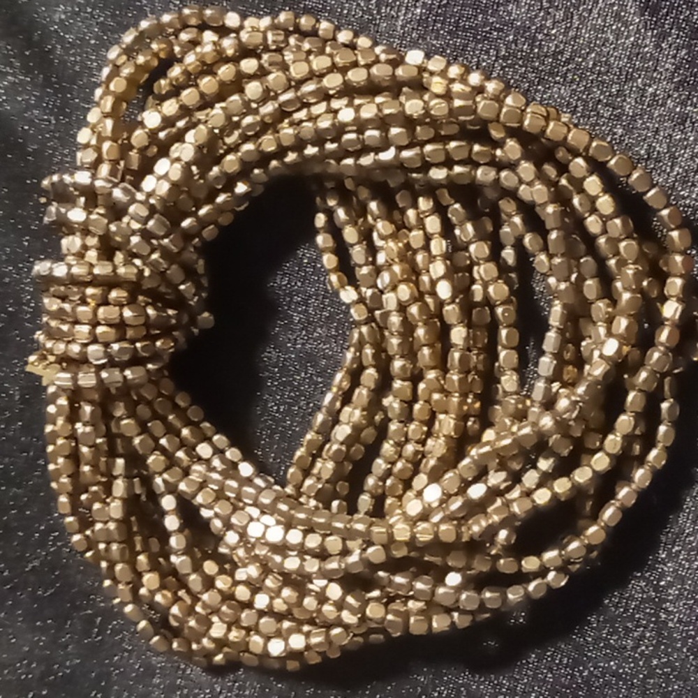 Metal seed beaded bracelet expandable brassy gold multi strand.